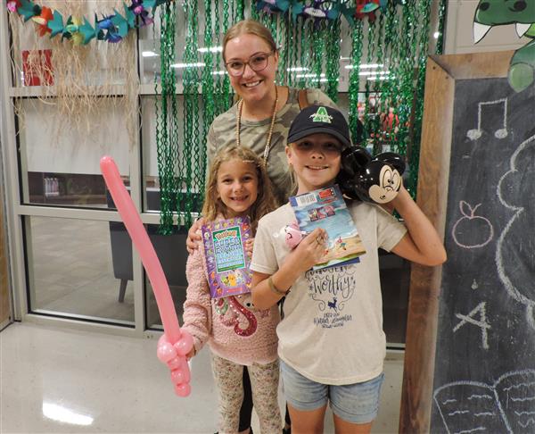 students and parents with stuff from the book fair